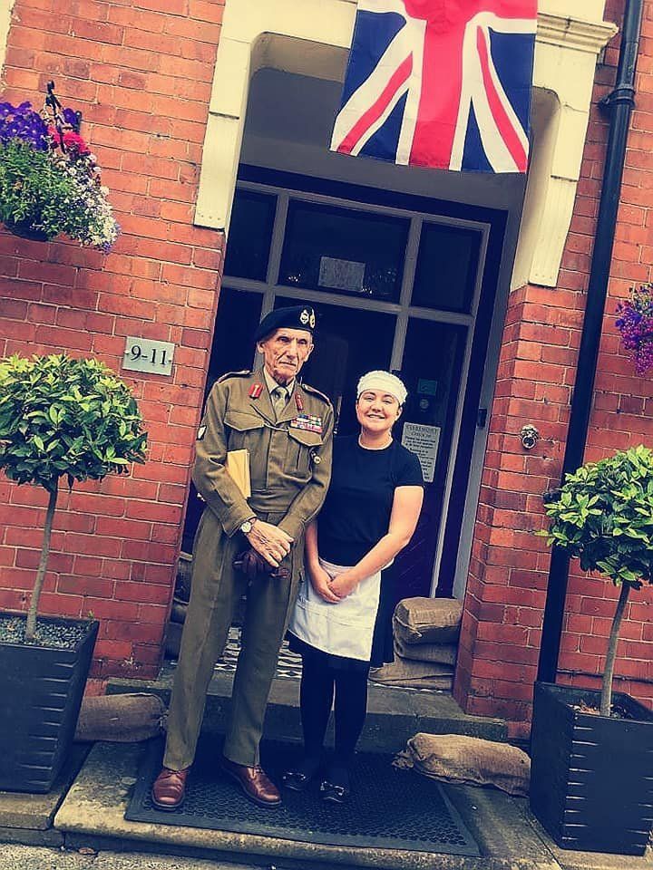 Two people in 1940s dress at The Claremont's front door