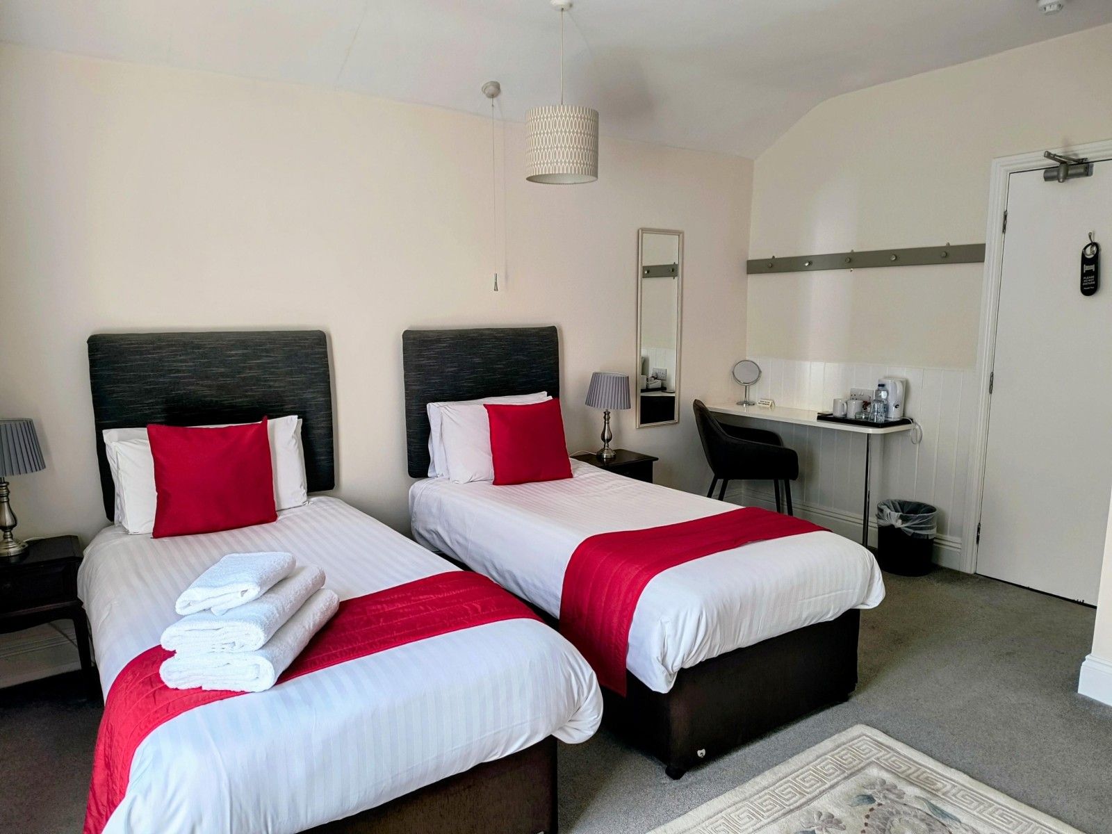 Twin room with red throws